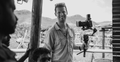 Blackacre founder Samuel Stirrat with a camera on set in Sri Lanka - BW