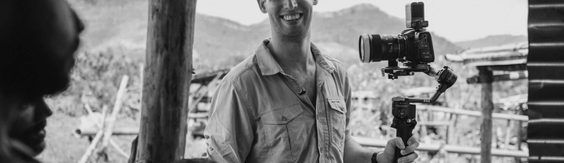 Blackacre founder Samuel Stirrat with a camera on set in Sri Lanka - BW