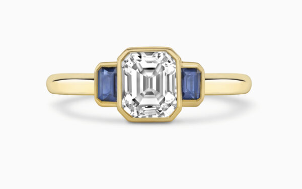 Emerald cut diamond with sapphire side stones - trilogy ring