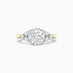 Unique 1 5ct round brilliant with pear shaped cluster side stone ring in yellow gold Through finger Front