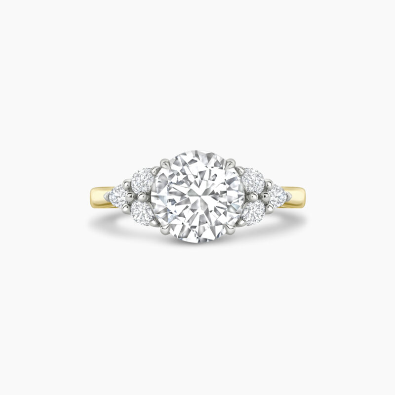 Unique 1 5ct round brilliant with pear shaped cluster side stone ring in yellow gold Through finger Front