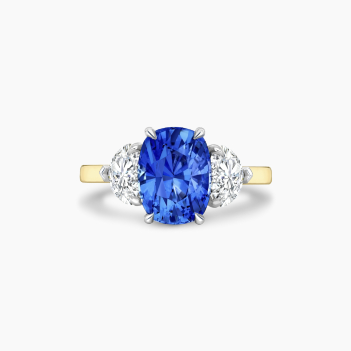 Venice 2ct Cushion cut royal blue sapphire and heart cut side stone trilogy ring in platinum and yellow gold Bespoke engagement ring